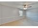 Bedroom with neutral carpet, ceiling fan, and natural light from window at 1920 E Edgewood Dr # D7, Lakeland, FL 33803
