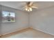 Cozy bedroom featuring neutral walls, a window view, and a ceiling fan, creating a relaxing space at 1920 E Edgewood Dr # D7, Lakeland, FL 33803