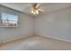 Bedroom featuring neutral carpet, ceiling fan, and window providing natural light at 1920 E Edgewood Dr # D7, Lakeland, FL 33803