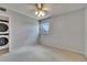 Neutral bedroom with carpet, ceiling fan, and visible stacked washer dryer at 1920 E Edgewood Dr # D7, Lakeland, FL 33803