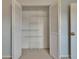 White bi-fold closet doors that open to reveal adjustable storage shelves at 1920 E Edgewood Dr # D7, Lakeland, FL 33803