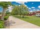 Well-maintained community grounds featuring grassy areas, mature trees, and walkway at 1920 E Edgewood Dr # D7, Lakeland, FL 33803