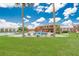 A serene community pool bordered by palm trees, with waterfront view at 1920 E Edgewood Dr # D7, Lakeland, FL 33803
