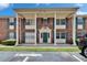 Attractive brick condo building featuring a covered entrance with stately columns and green shutters at 1920 E Edgewood Dr # D7, Lakeland, FL 33803