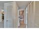 Hallway showing access to bathroom and laundry, with tile flooring at 1920 E Edgewood Dr # D7, Lakeland, FL 33803
