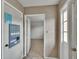 Hallway leading into a bright room with tile floors and natural light at 1920 E Edgewood Dr # D7, Lakeland, FL 33803