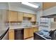 Practical kitchen featuring wood cabinets, stainless appliances, and access to the outside at 1920 E Edgewood Dr # D7, Lakeland, FL 33803