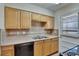 Functional kitchen showcasing countertops, wood cabinets, stainless sink, and modern appliances at 1920 E Edgewood Dr # D7, Lakeland, FL 33803