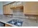 Well-lit kitchen with wood cabinets, neutral countertops, and a stainless steel double basin sink at 1920 E Edgewood Dr # D7, Lakeland, FL 33803