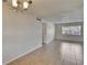 Bright living area featuring tile floors, a chandelier, and a window that brings in natural light at 1920 E Edgewood Dr # D7, Lakeland, FL 33803