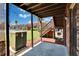View from covered patio featuring utility box, lawn, fence, and wooden staircase to upper-level balconies at 1920 E Edgewood Dr # D7, Lakeland, FL 33803