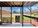 Screened-in patio offering views of a tennis court and well-maintained landscaping at 1920 E Edgewood Dr # D7, Lakeland, FL 33803