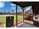 Patio view showcasing a tennis court, buildings, and manicured lawns at 1920 E Edgewood Dr # D7, Lakeland, FL 33803