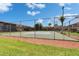 Exterior view features community tennis court, landscaping, and surrounding buildings at 1920 E Edgewood Dr # D7, Lakeland, FL 33803