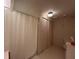 Bathroom with neutral color scheme, featuring a shower and closet space at 2055 S Floral Ave # 262, Bartow, FL 33830