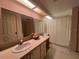 Dual-sink bathroom with well-lit mirrors and bathtub with shower at 2055 S Floral Ave # 262, Bartow, FL 33830