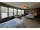 Spacious bedroom featuring two beds, a ceiling fan, and multiple windows at 2055 S Floral Ave # 262, Bartow, FL 33830
