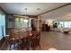Traditional dining room with wood table, chairs, built-in cabinet, opening to living area at 2055 S Floral Ave # 262, Bartow, FL 33830