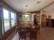 Traditional dining room with wood table, chairs, built-in cabinet, and natural light from windows at 2055 S Floral Ave # 262, Bartow, FL 33830