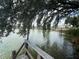 Scenic dock view of the lake with mature trees, and tranquil waterfront creating the ideal location for relaxation and waterfront enjoyment at 2055 S Floral Ave # 262, Bartow, FL 33830