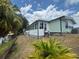 Exterior view showing a single-story home with a sunroom addition and access to waterfront at 2055 S Floral Ave # 262, Bartow, FL 33830