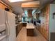 Spacious kitchen with wood cabinets, an island cooktop, and modern appliances at 2055 S Floral Ave # 262, Bartow, FL 33830