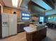 Large kitchen with wood cabinets, an island cooktop, and updated appliances at 2055 S Floral Ave # 262, Bartow, FL 33830