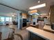 Bright kitchen featuring wood cabinetry, modern appliances and an adjacent living area at 2055 S Floral Ave # 262, Bartow, FL 33830