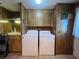 Laundry room with washer, dryer, sink, cabinets and a laminate floor at 2055 S Floral Ave # 262, Bartow, FL 33830