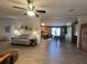 Open living space with sofa, lamps, and an open floorplan connecting to the kitchen and dining area at 2055 S Floral Ave # 262, Bartow, FL 33830