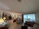 Spacious open living area with natural light and seamless connection to the sunroom, some clutter visible at 2055 S Floral Ave # 262, Bartow, FL 33830