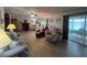 Open living space with sofa, lamps, and an open floorplan connecting to a sun room at 2055 S Floral Ave # 262, Bartow, FL 33830