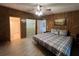 Wood-paneled bedroom with bed, ensuite bathroom, and walk-in closet at 2055 S Floral Ave # 262, Bartow, FL 33830