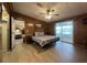 Wood-paneled bedroom with bed, slider to sunroom, and connecting living area at 2055 S Floral Ave # 262, Bartow, FL 33830