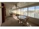Sunlit sunroom featuring two tables and panoramic views of the tranquil lake at 2055 S Floral Ave # 262, Bartow, FL 33830