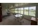 Bright sunroom with multiple tables, ceiling fans, and a scenic view of the lake at 2055 S Floral Ave # 262, Bartow, FL 33830