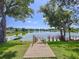 A backyard walkway leading down to a lake with a relaxing, peaceful view in the distance at 2055 S Floral Ave # 291, Bartow, FL 33830