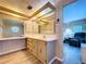 Bathroom featuring light wood cabinets, light walls, and access to the main bedroom at 2055 S Floral Ave # 291, Bartow, FL 33830