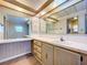 Bright bathroom featuring wood grain cabinets, neutral countertops, and a large mirror at 2055 S Floral Ave # 291, Bartow, FL 33830