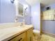 A well-lit bathroom features blue walls, a vanity with a white tiled backsplash, and traditional fixtures at 2055 S Floral Ave # 291, Bartow, FL 33830