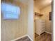 Bedroom showing a window with blinds and a walk-in closet with built-in shelving and a dresser at 2055 S Floral Ave # 291, Bartow, FL 33830