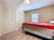 Bedroom features wood-paneled walls, a ceiling fan, window and closet at 2055 S Floral Ave # 291, Bartow, FL 33830