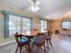 Bright dining area features stylish wood table and chairs, as well as views of the sun room at 2055 S Floral Ave # 291, Bartow, FL 33830