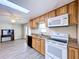 Kitchen featuring wood cabinets, black appliances, and a skylight at 2055 S Floral Ave # 291, Bartow, FL 33830