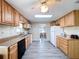 The kitchen features wood cabinets and flooring, and a view into the dining area at 2055 S Floral Ave # 291, Bartow, FL 33830