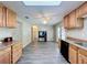 The kitchen features wood cabinets, gray flooring, and a skylight for plenty of natural light at 2055 S Floral Ave # 291, Bartow, FL 33830