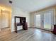Open living room with a desk area, door to the backyard, and gray flooring at 2055 S Floral Ave # 291, Bartow, FL 33830