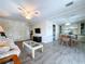 Open concept living and dining area with ceiling fans and stylish gray wood-look flooring at 2055 S Floral Ave # 291, Bartow, FL 33830