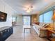 Spacious and open living area with stylish furniture, natural light, and an adjacent sunroom for versatile living at 2055 S Floral Ave # 291, Bartow, FL 33830