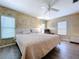 Main bedroom featuring a ceiling fan, two windows, and a bed at 2055 S Floral Ave # 291, Bartow, FL 33830